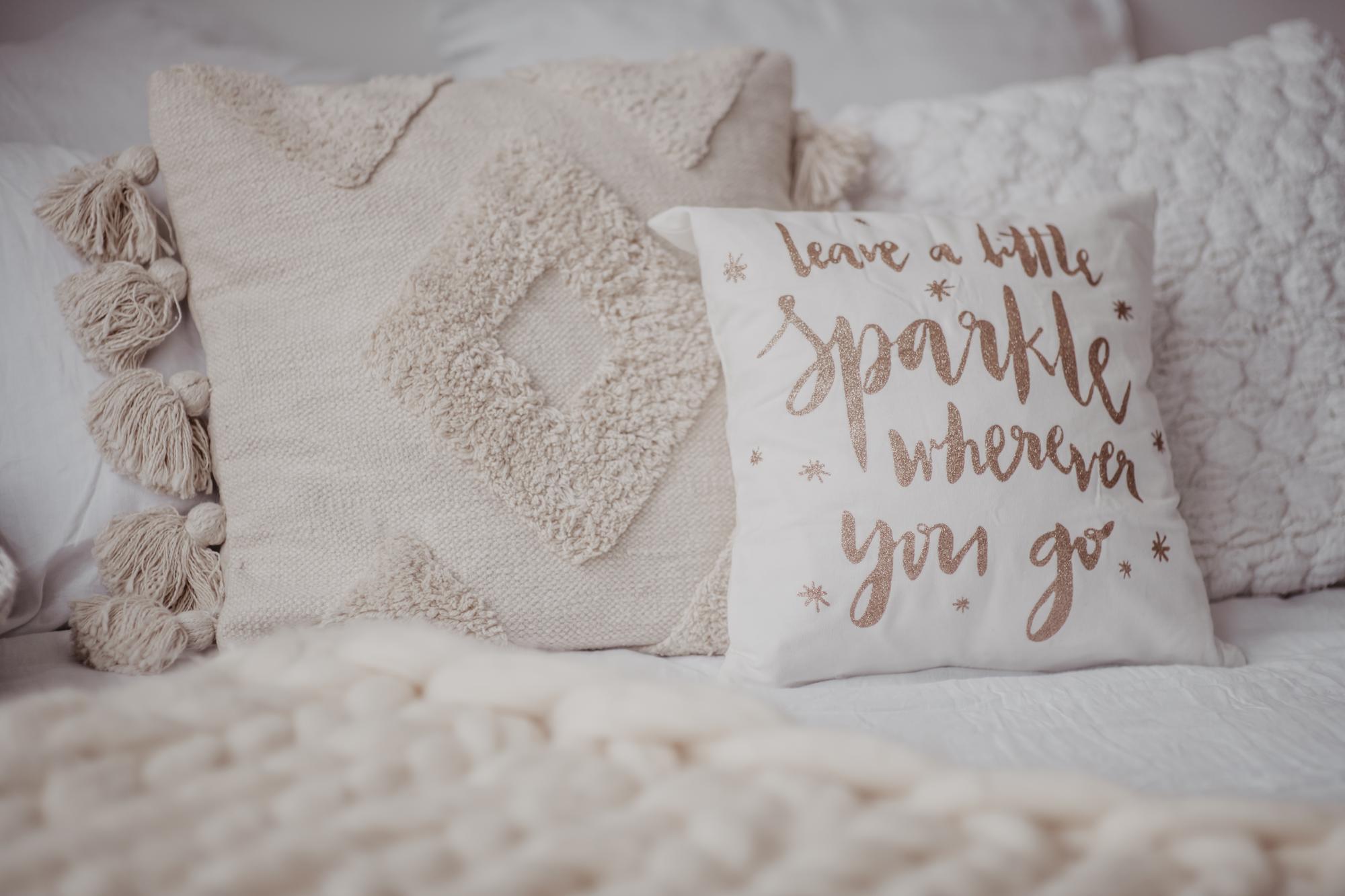 Series of embroidered cushions in neutral tones